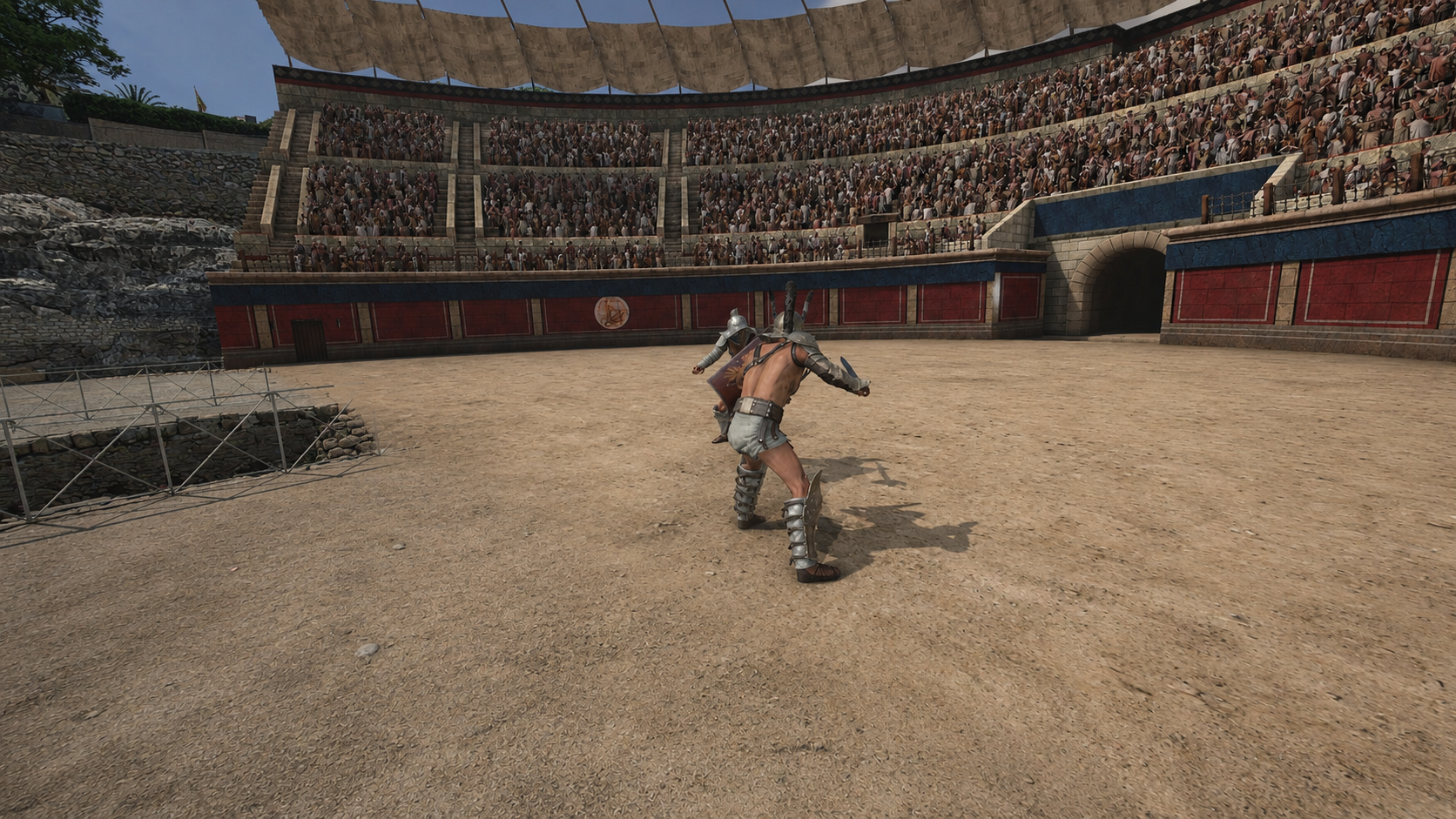 Two gladiators facing each other on the arena sand in front of a full amphitheatre